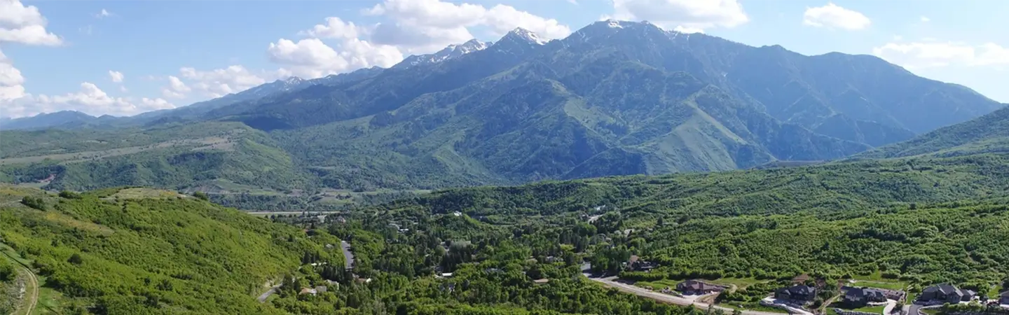 Aerial view of a Wasatch Front neighborhood beneath the mountains